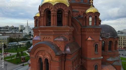 Aerial view of the beautiful Alexander Nevsky Cathedral Drone rotates over the old church with golden domes in the city center Beautiful temple