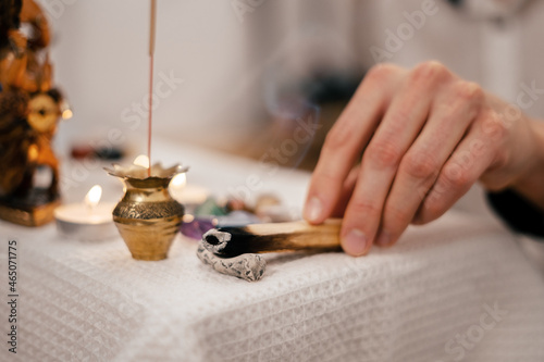 Palasanta's wand smokes and smells on a stand on the meditation altar photo