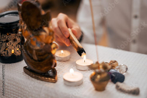 The palasata wand is lit from a candle above the altar for meditation. photo