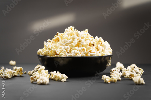 Popcorn in a bowl on a dark background.