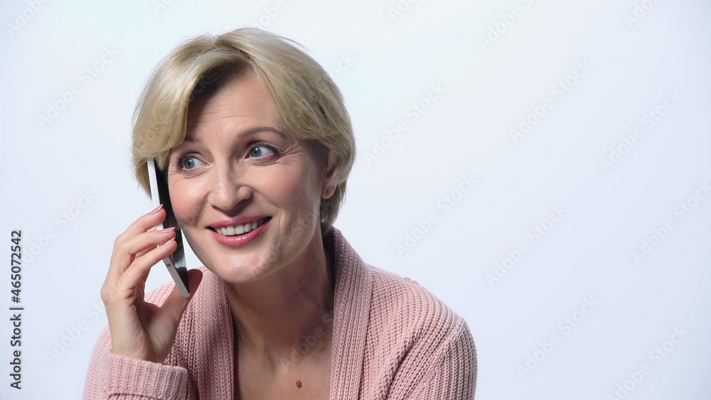 positive middle aged woman calling on mobile phone isolated on white. positive middle aged woman calling on mobile phone isolated on white.
