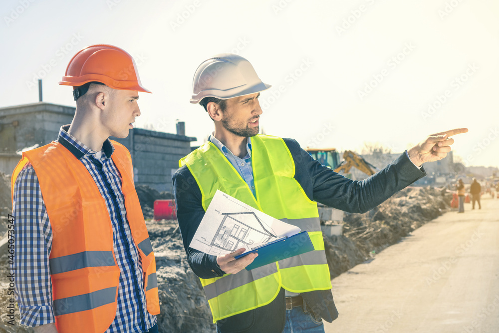 Group of construction engineers on a building plot. Real Estate Project with Civil Engineer.