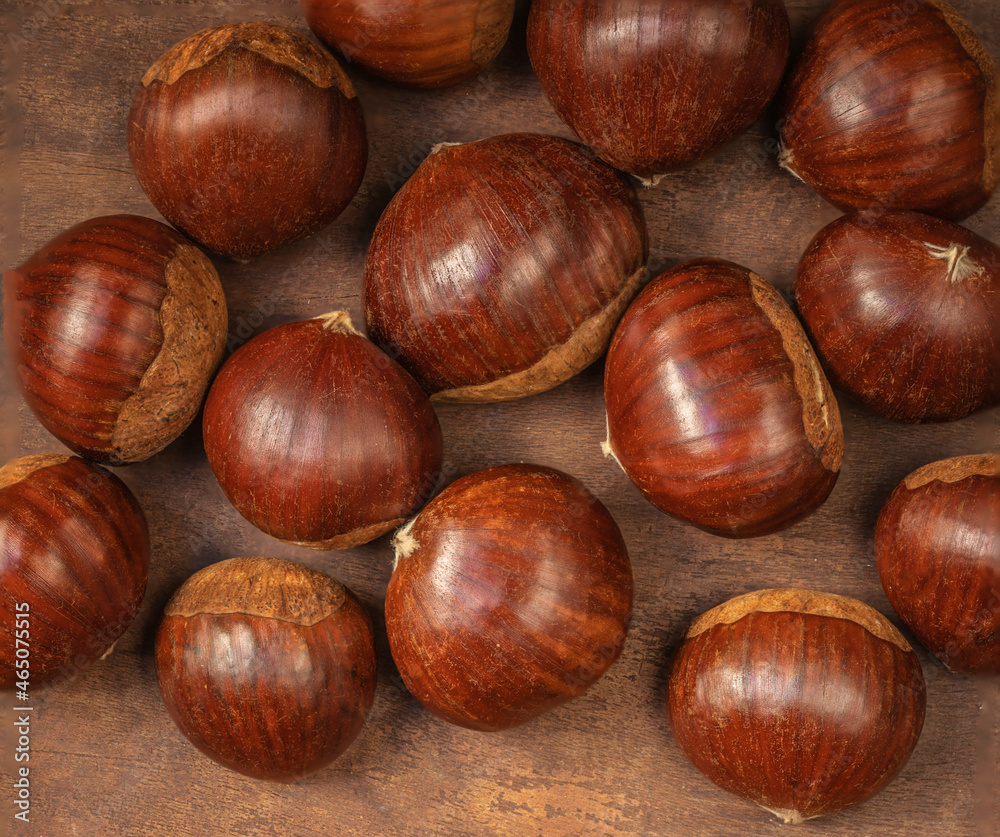 Chestnuts on on an old board with copy space. Autumn fall concept. Horse chestnuts top view. Chestnuts on on an old board with copy space. Autumn fall concept. Horse chestnuts top view.
