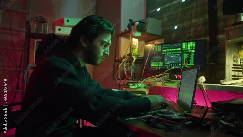 Angry hacker typing on keyboard at night, fail with breaking password, using laptop and bypassing cybersecurity. Young man developing program in dark room. Programmer infecting system with cyber virus Angry hacker typing on keyboard at night, fail with breaking password, using laptop and bypassing cybersecurity. Young man developing program in dark room. Programmer infecting system with cyber virus