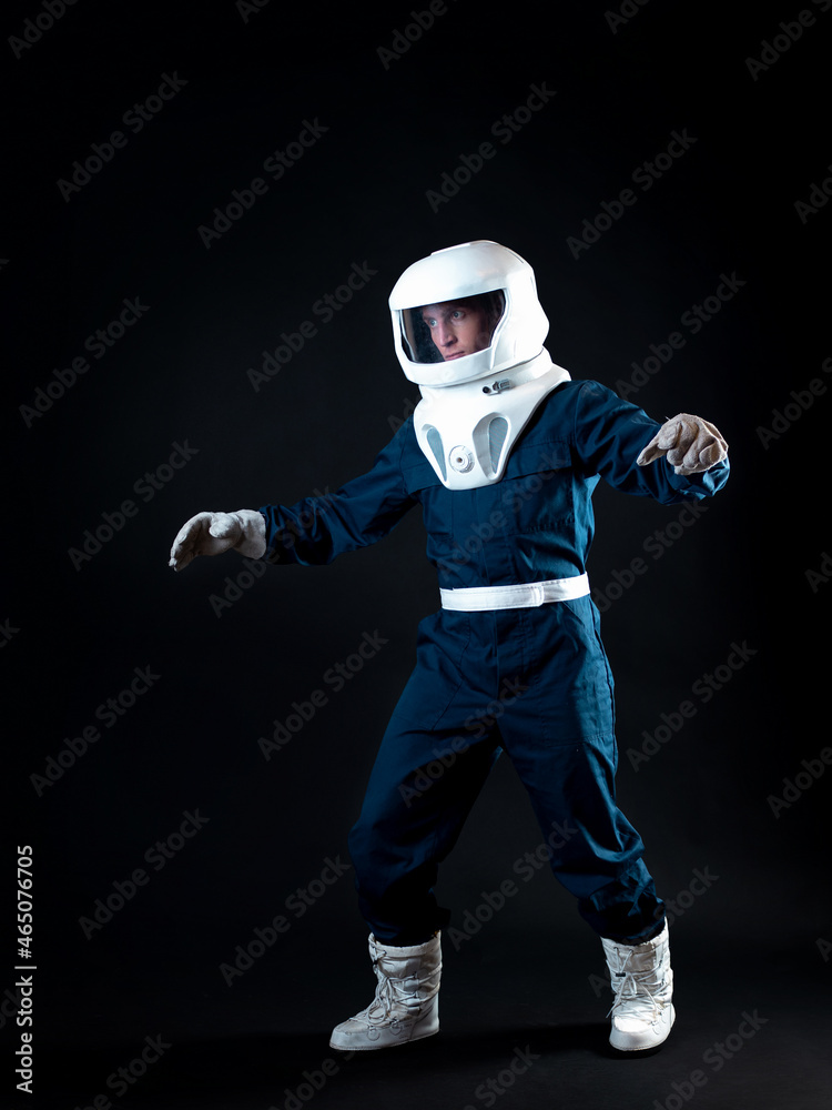 The astronaut is floating in weightlessness. The hero of the science fiction story is a pioneer of space exploration. A young man in a space suit The astronaut is floating in weightlessness. The hero of the science fiction story is a pioneer of space exploration. A young man in a space suit
