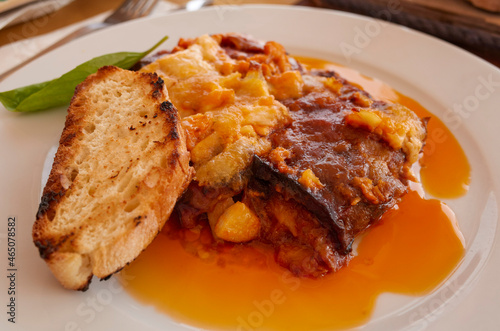 Parmigiana with aubergines and a slice of bread