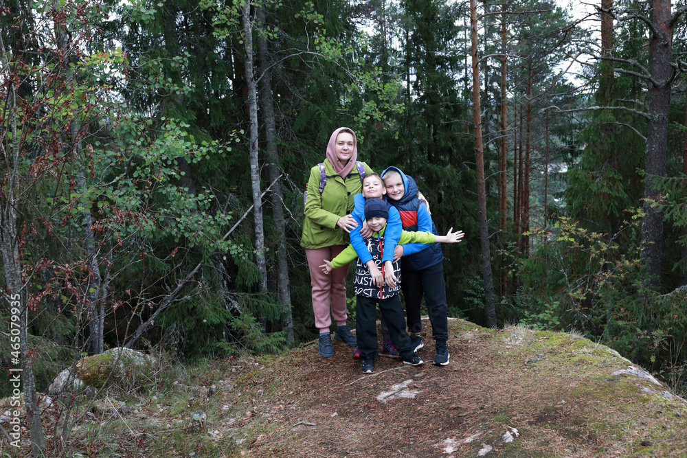 Fototapeta premium Mother and son at foot of Mount Hiidenvuori