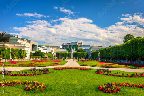 Beautiful view of famous Mirabell Gardens with the old historic Fortress Hohensalzburg in the background in Salzburg, Austria. Famous Mirabell Gardens with historic Fortress in Salzburg, Austria. © daliu