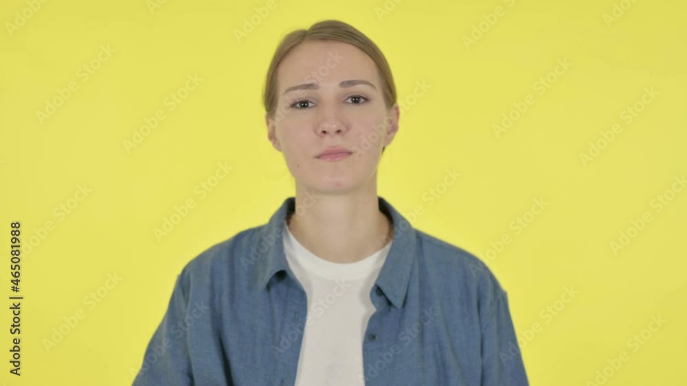 Young Woman Showing No Sign by Arm Gesture on Yellow Background Young Woman Showing No Sign by Arm Gesture on Yellow Background