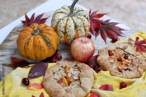 Squash galettas with cinnamon and honey on wooden cutting board. Top view photo of tasty autumn dessert.  photo