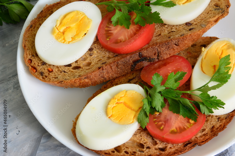 sandwiches with eggs, tomatoes and parsley, close up sandwiches with eggs, tomatoes and parsley, close up