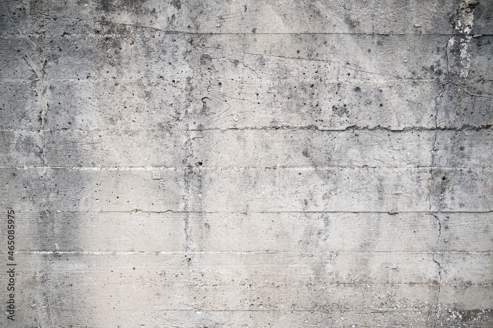 Old concrete wall with defects and roughness, with a pattern in the form of horizontal stripes