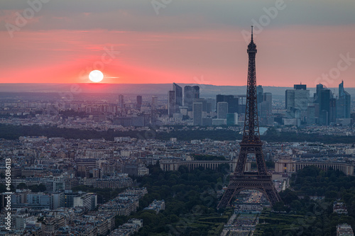 Panoramic aerial view of Paris, Eiffel Tower and La Defense business district. Aerial view of Paris at sunset. Panoramic view of Paris skyline with Eiffel Tower and La Defense. Paris, France. © daliu