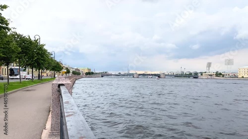 Saint Petersburg, Russia, August 2021: Makarov Embankment of the Neva River. Boats are sailing along the river, cars and buses are riding along the road. There is no one on the embankment