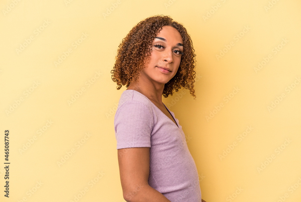 Young latin transsexual woman isolated on yellow background confident keeping hands on hips. Young latin transsexual woman isolated on yellow background confident keeping hands on hips.