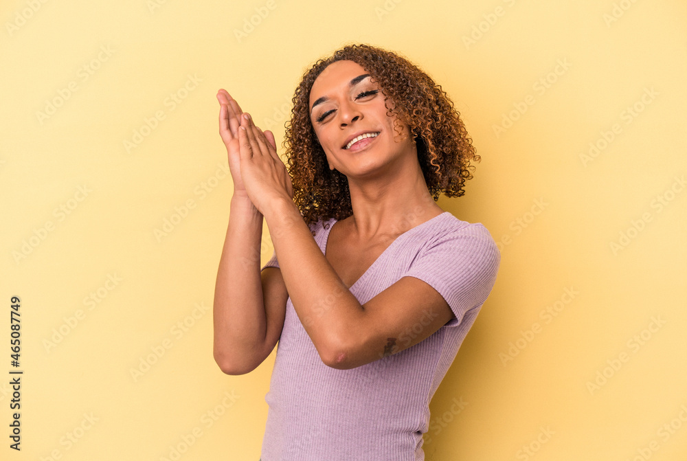 Young latin transsexual woman isolated on yellow background feeling energetic and comfortable, rubbing hands confident. Young latin transsexual woman isolated on yellow background feeling energetic and comfortable, rubbing hands confident.