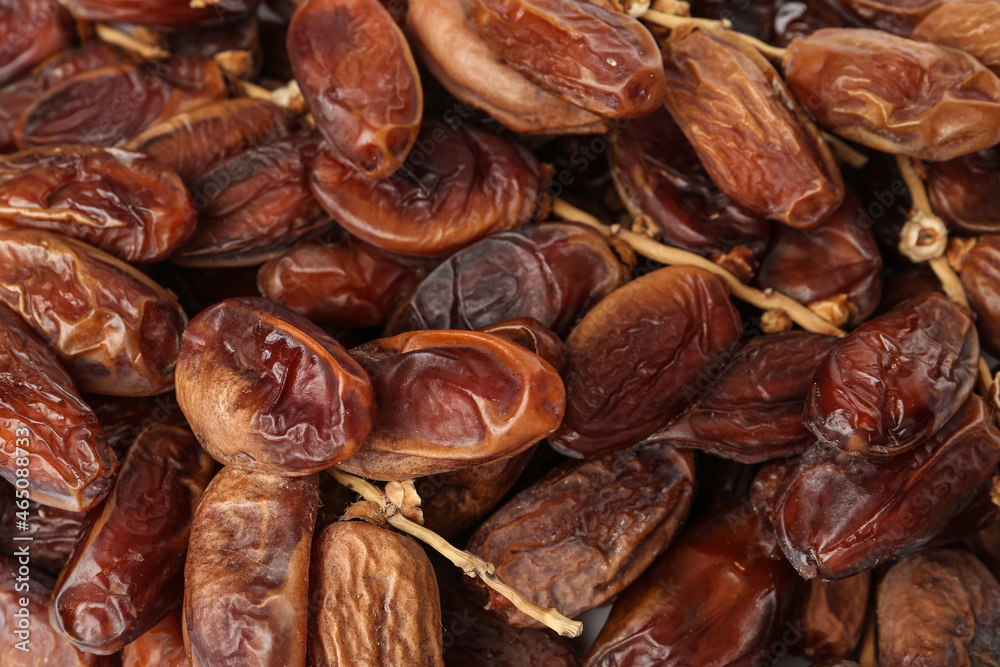 Sweet dried dates on branches as background, closeup. Healthy snack Sweet dried dates on branches as background, closeup. Healthy snack
