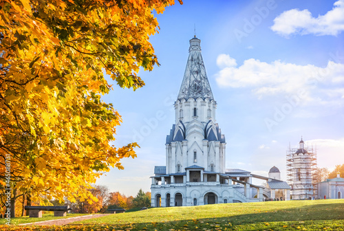 Golden autumn trees and the Ascension Church in Kolomenskoye park in Moscow on an autumn sunny day