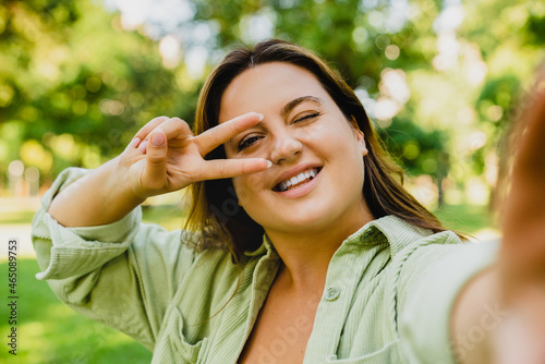 Wallpaper Mural Close up image of a young caucasian woman student freelancer taking selfie photo image, posing at camera on smart phone, having video call, posting on social media outdoors. Torontodigital.ca