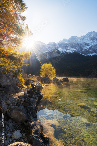 Beautiful morning in the alps at lake Eibsee and mountain zugspitze. Hiking in the morning in fall