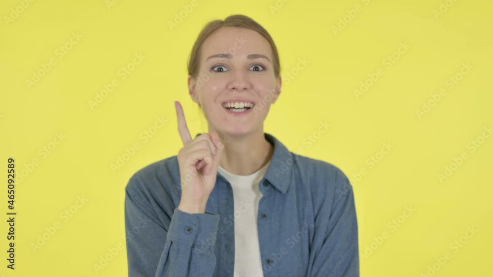 Pensive Young Woman Thinking and getting Idea on Yellow Background Pensive Young Woman Thinking and getting Idea on Yellow Background