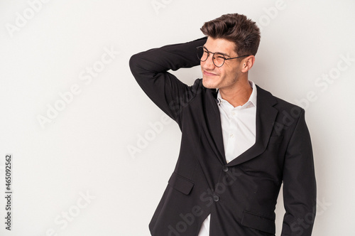 Young business caucasian man isolated on white background touching back of head, thinking and making a choice.
