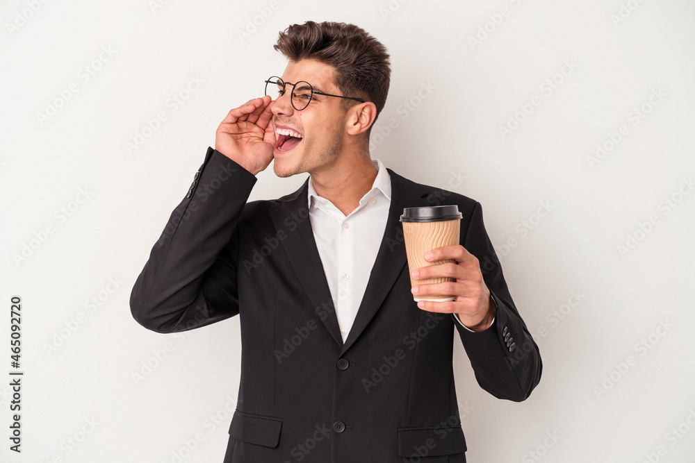 Young business caucasian man holding take away coffee isolated on white background shouting and holding palm near opened mouth. Young business caucasian man holding take away coffee isolated on white background shouting and holding palm near opened mouth.