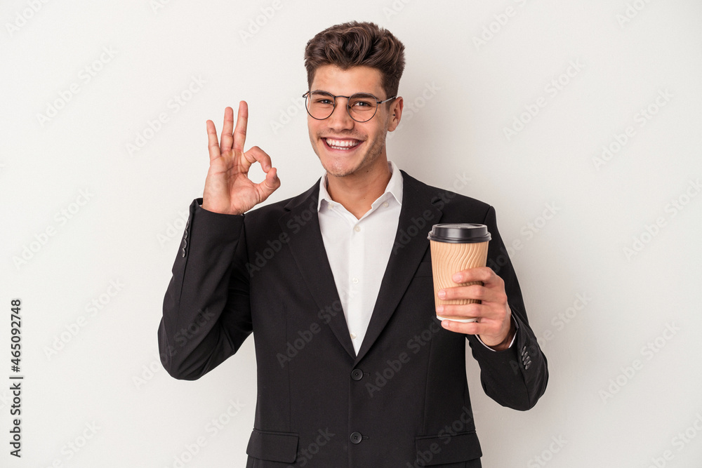 Young business caucasian man holding take away coffee isolated on white background cheerful and confident showing ok gesture. Young business caucasian man holding take away coffee isolated on white background cheerful and confident showing ok gesture.