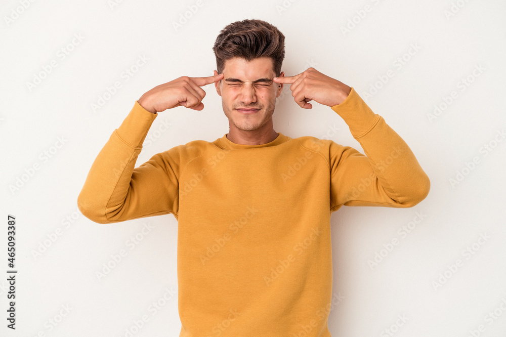 Young caucasian man isolated on white background focused on a task, keeping forefingers pointing head. Young caucasian man isolated on white background focused on a task, keeping forefingers pointing head.