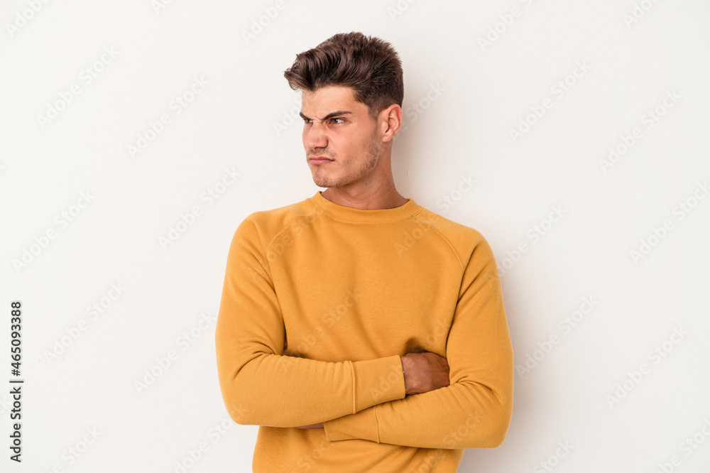 Young caucasian man isolated on white background tired of a repetitive task. Young caucasian man isolated on white background tired of a repetitive task.