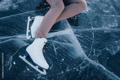 figure skates on ice top view. legs of a figure skater girl