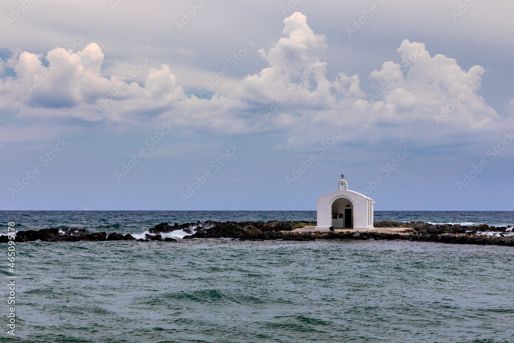 Agios Nikolaos Chapel, Georgioupoli, Crete, white chapel is built on a small rocky islet and is dedicated to Saint Nicholas. Agios Nikolaos Saint Nicholas church, Giorgoupoli in Crete, Greece