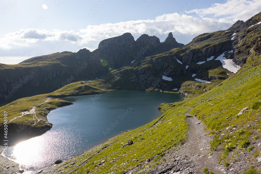 Naklejka premium Amazing hiking day in one of the most beautiful area in Switzerland called Pizol in the canton of Saint Gallen. What a wonderful landscape in Switzerland at a sunny day. Beautiful blue alpine lake.