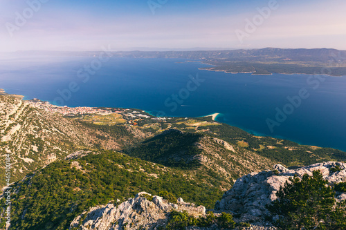 View on mountains and sea from Vidova Gora on Brac island. View from the mountain Vidova Gora on the island Brac in Croatia with the famous landmark Zlatni Rat near the city of Bol an the blue sea. photo