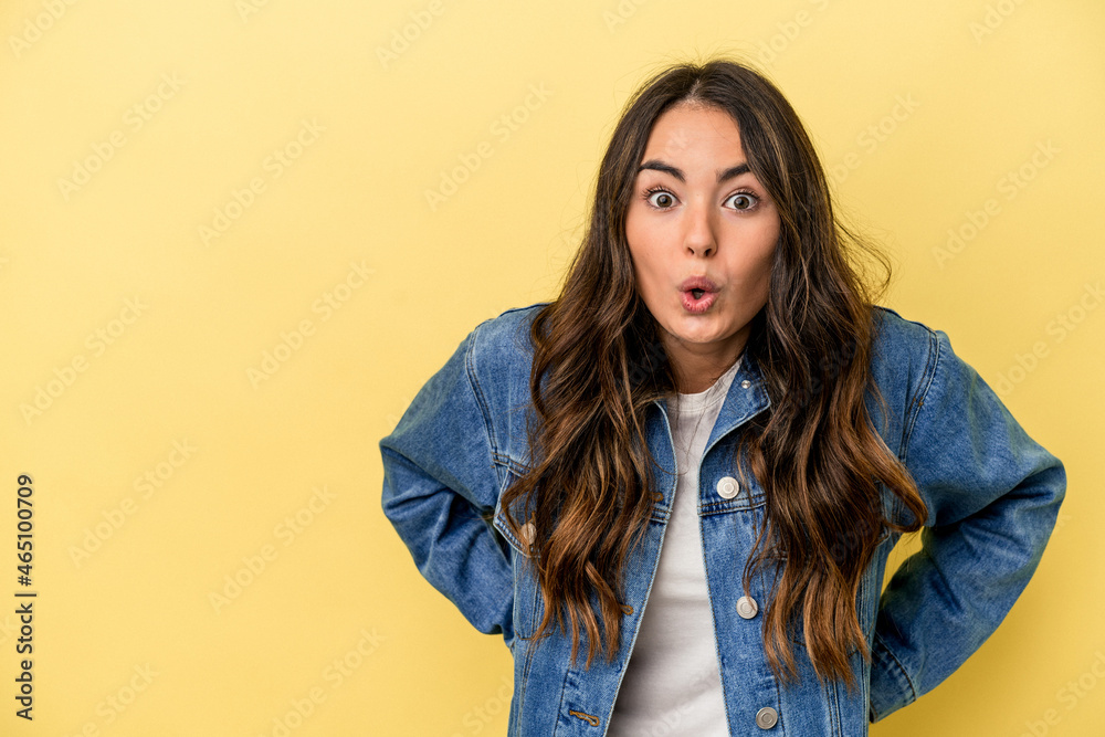 Young caucasian woman isolated on yellow background being shocked because of something she has seen. Young caucasian woman isolated on yellow background being shocked because of something she has seen.