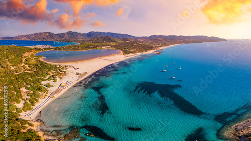 Fototapeta Naklejka Na Ścianę i Meble -  Torre di Porto Giunco Tower and Simius Beach near Villasimius, Sardinia, Italy. View from flying drone. Torre di Porto Giunco tower on Carbonara cape. Aerial morning view of Sardinia island, Italy