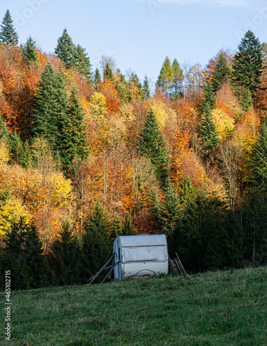 abandoned caravan on grassland at autumn
