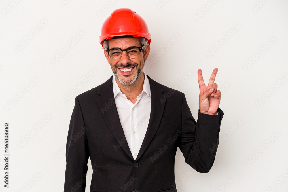 Middle age architect caucasian man isolated on white background joyful and carefree showing a peace symbol with fingers. Middle age architect caucasian man isolated on white background joyful and carefree showing a peace symbol with fingers.