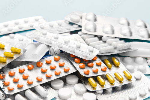 Treatment concept. Heap of many blisters of medical pills, tablets on blue background. Perspective view of pharmacy drug. Healthcare concept. pharmaceutical background from medicaments. Vitamin