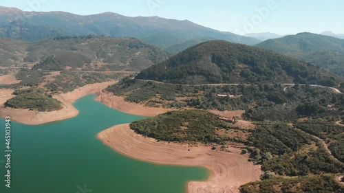 Aerial aerial drone shot of a swamp. The lake shines on a sunny day with the hills outlining its clear waters