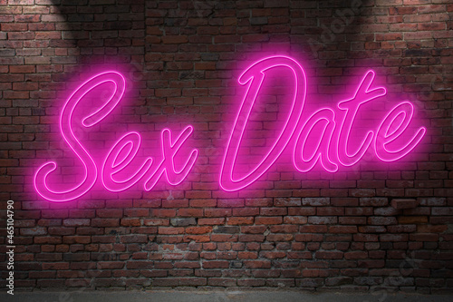 Neon Sex Date lettering on Brick Wall at night