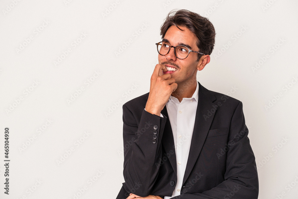 Young mixed race business man isolated on white background relaxed thinking about something looking at a copy space. Young mixed race business man isolated on white background relaxed thinking about something looking at a copy space.