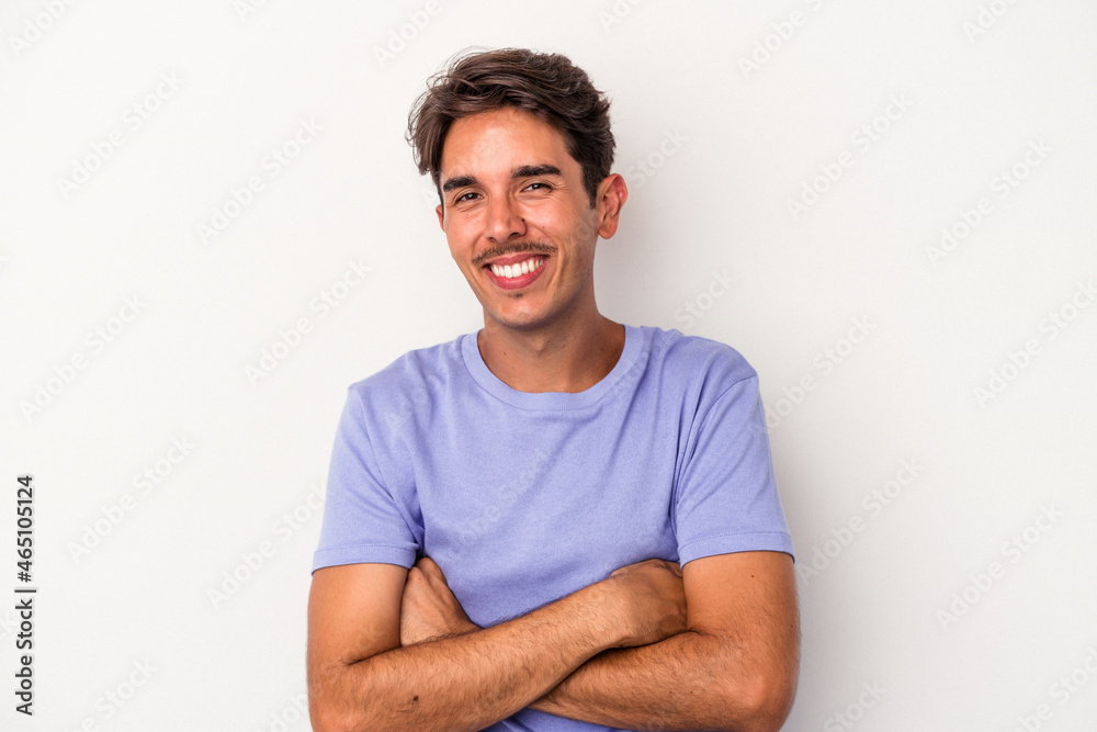 Young mixed race man isolated on white background laughing and having fun. Young mixed race man isolated on white background laughing and having fun.