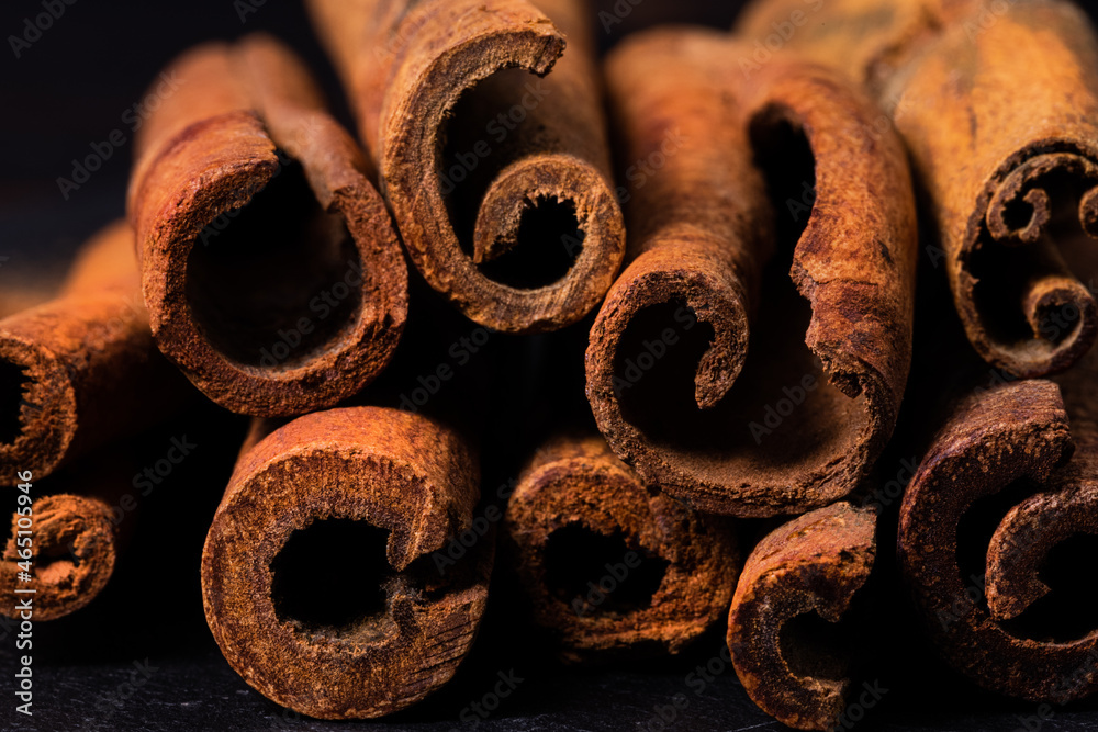 cinnamon sticks close up on dark background