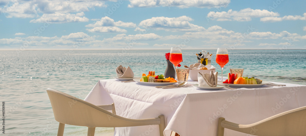 Poster Wandbilder Luxury breakfast table with food for two with beautiful tropical sea view background 50x22.3 cm
