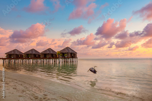 Stunning colorful sunset sky with clouds seaside horizon. Lagoon landscape in Maldives. Luxury traveling destination  exotic summer beach view. Tropical vacation and summer holiday background concept