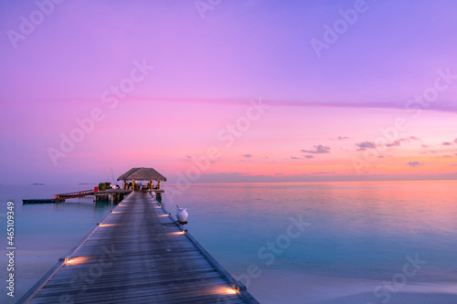 Stunning colorful sunset sky with clouds seaside horizon. Lagoon landscape in Maldives. Luxury traveling destination, exotic summer beach view. Tropical vacation and summer holiday background concept