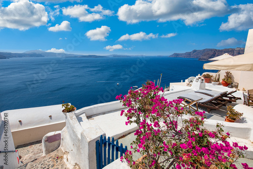Greek island of Santorini. Amazing travel panorama, white houses, stairs and flowers on the streets. Idyllic summer vacation, urban landscape, tourism destination scenic. Oia, Thira panoramic views