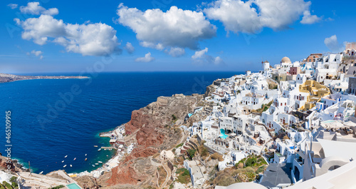 Fototapeta Naklejka Na Ścianę i Meble -  Greek island of Santorini. Amazing travel panorama, white houses, stairs and flowers on the streets. Idyllic summer vacation, urban landscape, tourism destination scenic. Oia, Thira panoramic views