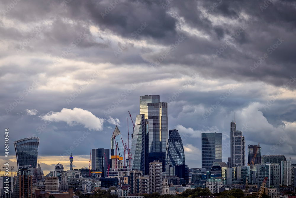Skyline of the City of London with grey clouds during stormy autumn season